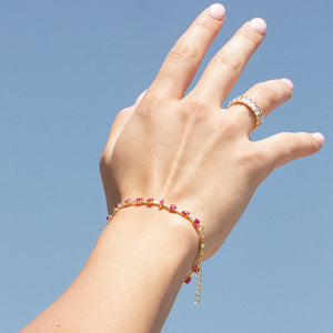 gold tennis bracelet with ruby color gemstones