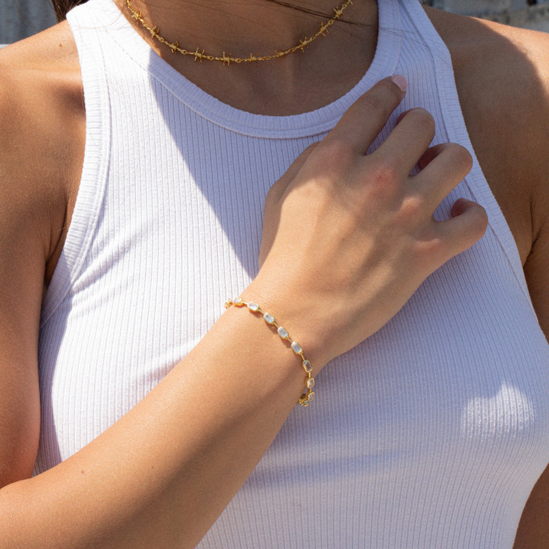 gold tennis bracelet with gemstones